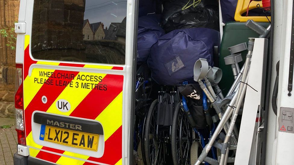 Wheelchairs, crutches and other medical equipment inside an ambulance