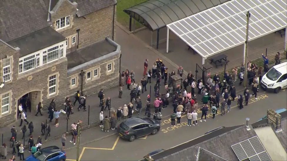 Crowds of parents lined up outside the school