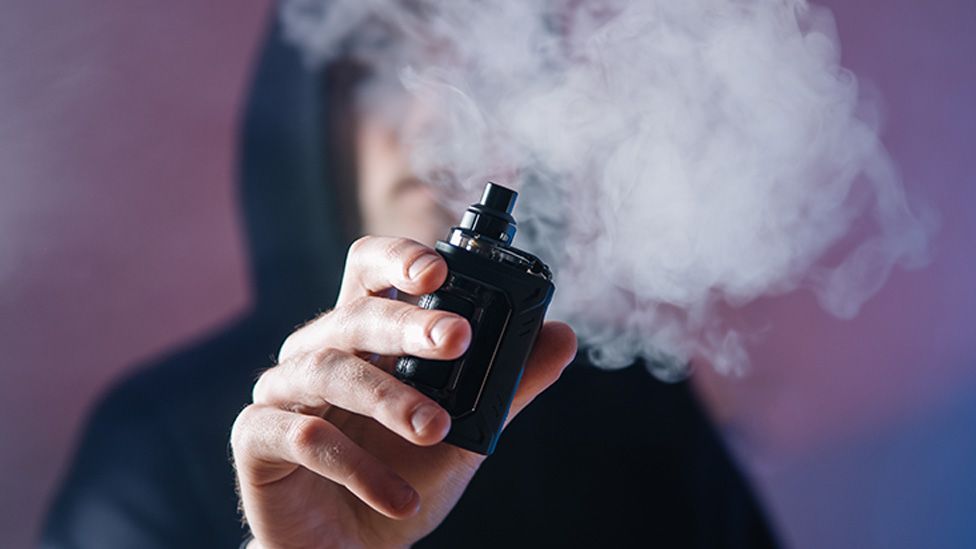 Stock image of a person smoking a vape