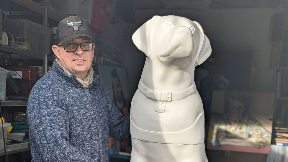 Mr Gavaghan with a sculpture of a guide dog