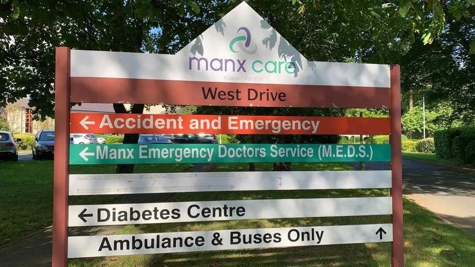 A Manx Care sign at Noble's which points in the direction for ambulances