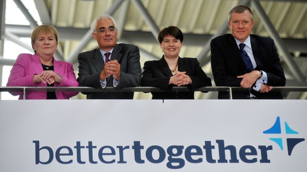 Scottish Labour leader Johann Lamont, Better Together chairman Alistair Darling, Scottish Conservative leader Ruth Davidson and Scottish LibDem leader Willie Rennie leaning over a Better Together sign