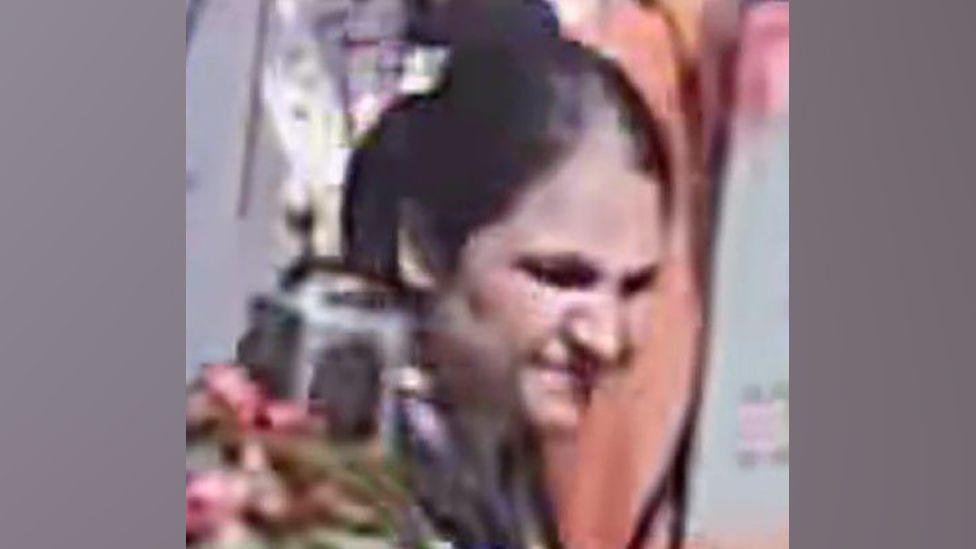 CCTV still of a woman smiling
