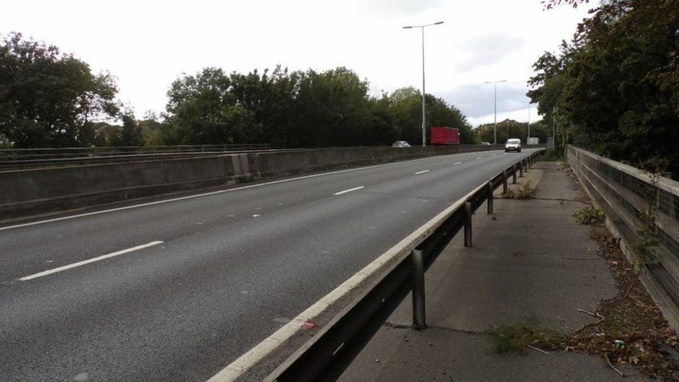 Dual carriageway bridge with central reservation with vehicles in the distance