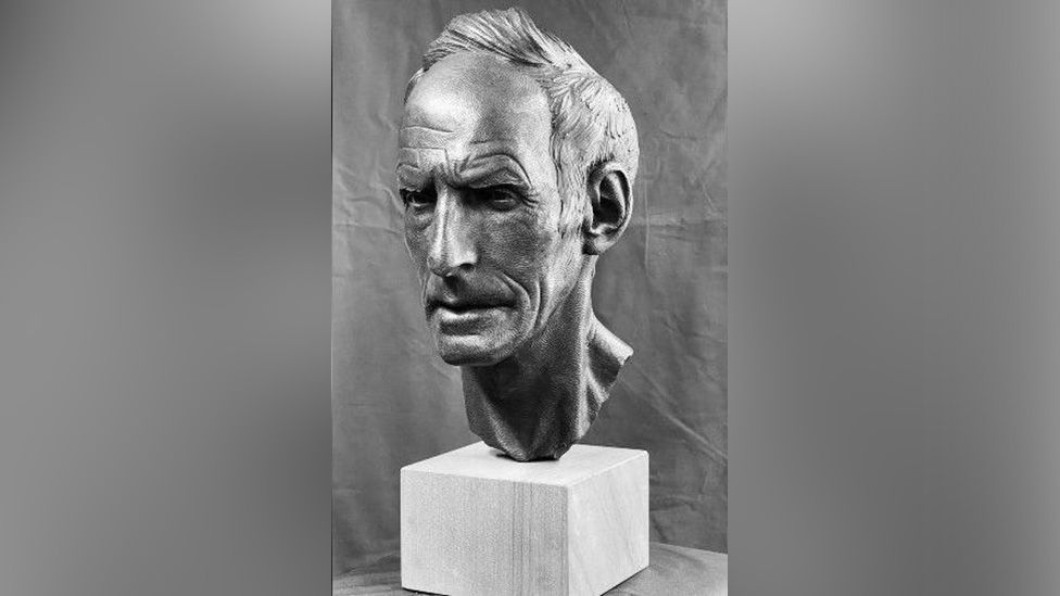 A black-and-white photo of the sculpture of Joss Naylor's head and neck. The face has a stern expression.