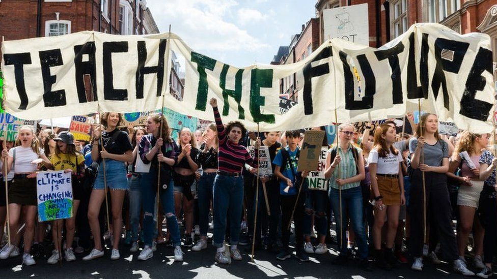Teach the Future banner held by teenagers at a climate demonstration in 2020