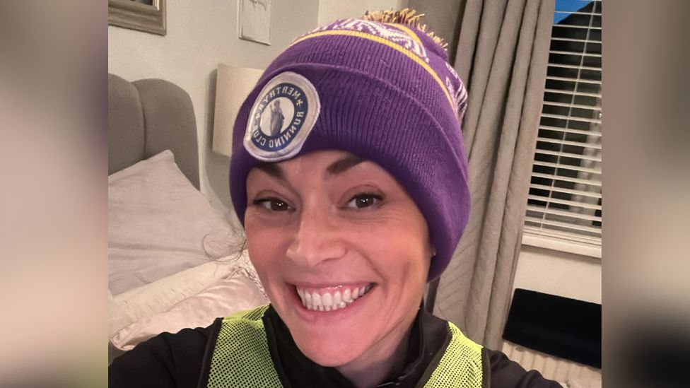 Selfie of Natalie with a Merthyr Running Club bobble hat