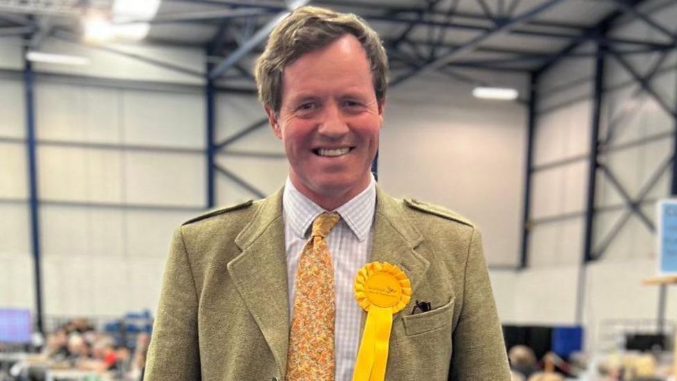 Angus MacDonald smiling after winning the Inverness, Skye and West Ross-shire 