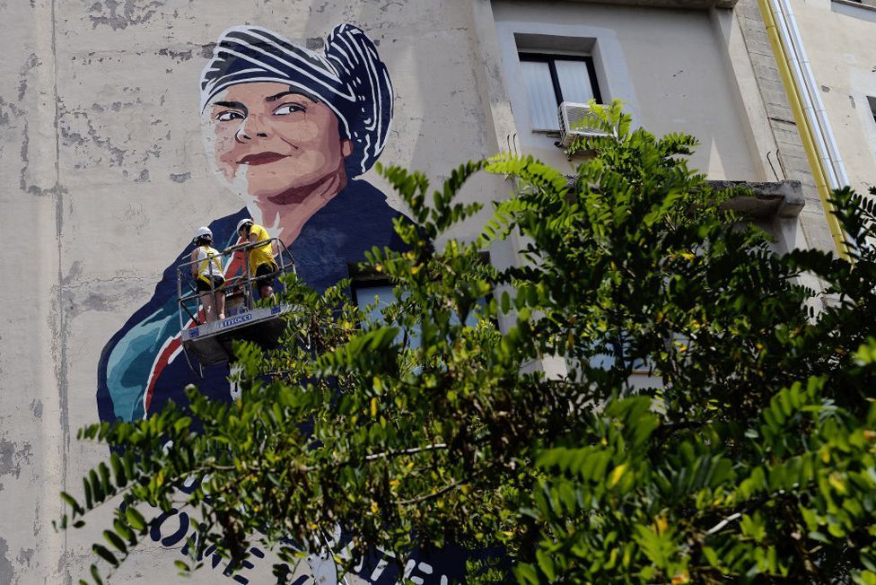 The face of Italian writer Michela Murgia is painted by street artist Laika on a wall in Rome