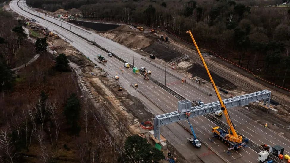 A crane on the M25 the last time road was closed, with no traffic on the road