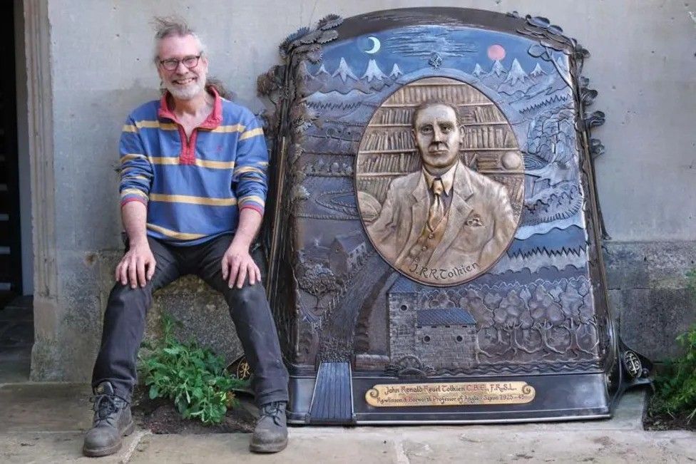 Tim Tolkien alongside his bronze sculpture of JRR Tolkien