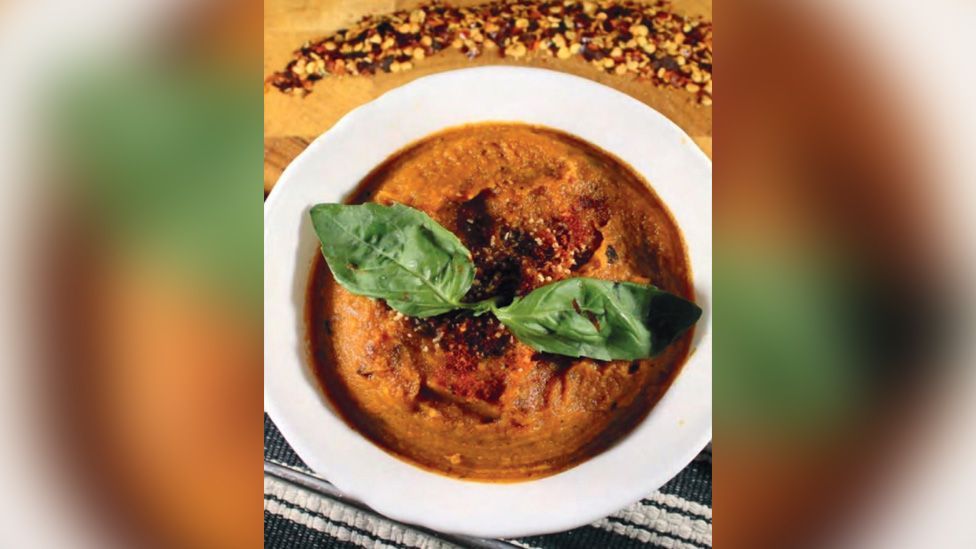 Sweet potato hummus with basil leaves and chilli flakes