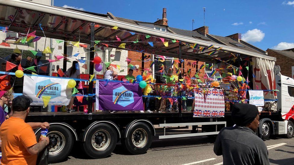 Parade from previous carbinal showing colourful float with bunting