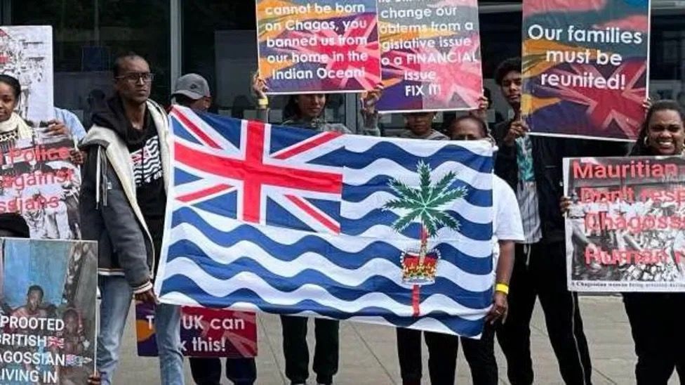 Chagos Islanders holding posters and flags