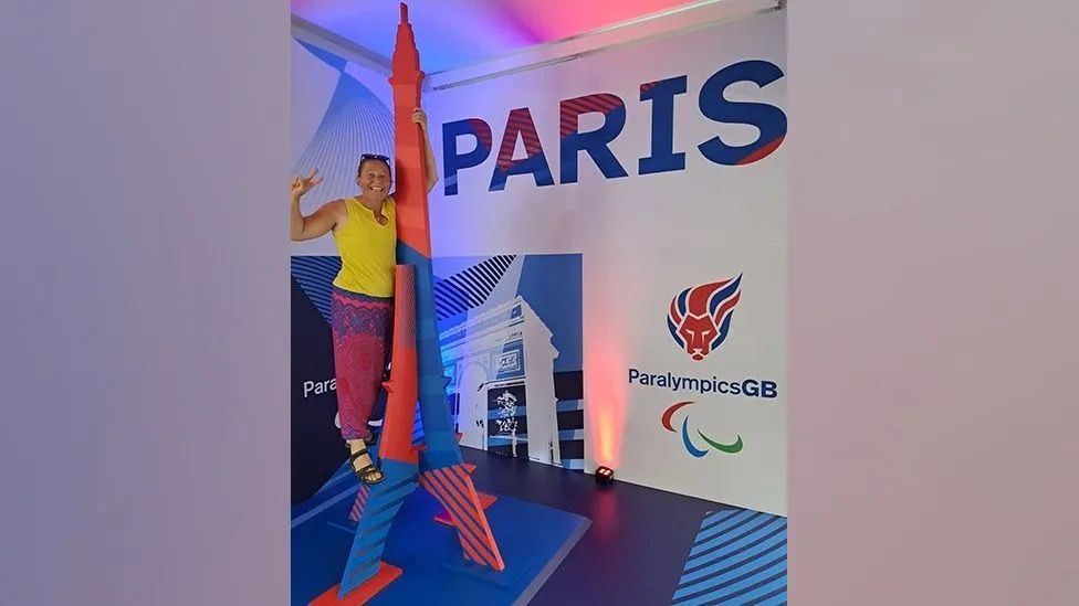 Kim Brinkworth standing in front of a Paris Paralymics GB display.