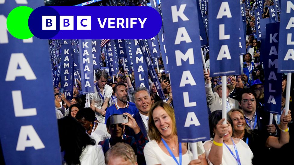 Audience members hold signs saying 'Kamala' at the Democratic National Convention on 22 August in Chicago