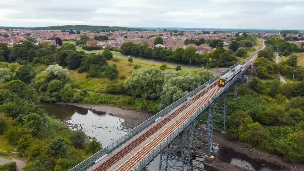 Train crossing a bridge over a river