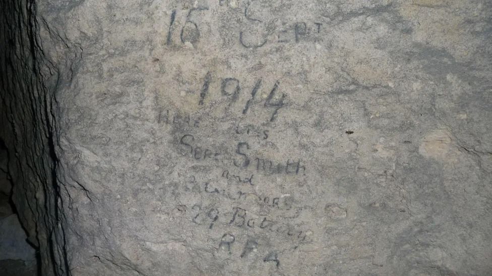 Cave carvings read: "15 Sept 1914, Here lies Sjt Smith and 3 Gnrs, 29th Battery RFA"
