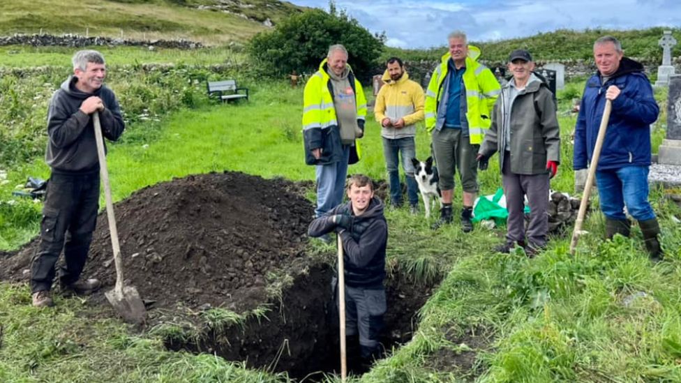 Seven men grave digging in Inishbofin