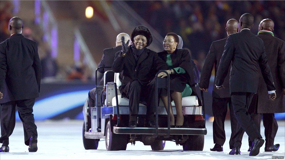 Nelson Mandela sits next to his wife Graca Machel as he greets fans during the closing ceremony of the 2010 World Cup at Soccer City stadium in Johannesburg July 11, 2010.