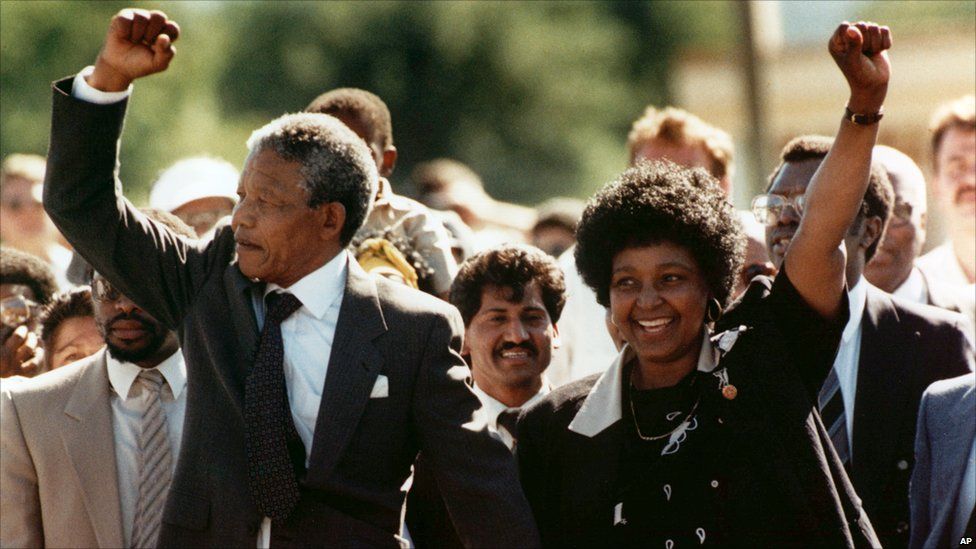 Nelson Mandela and wife Winnie, walking hand in hand, raise clenched fists upon his release from Victor prison, Cape Town, 11 February 1990