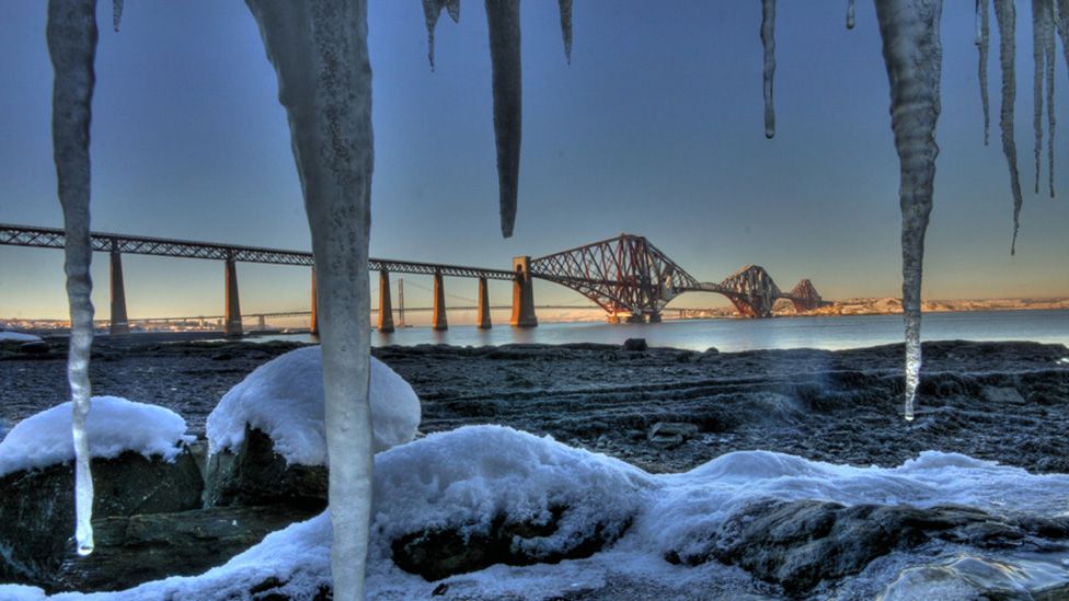 ice frames the Forth Bridge on a frosty day