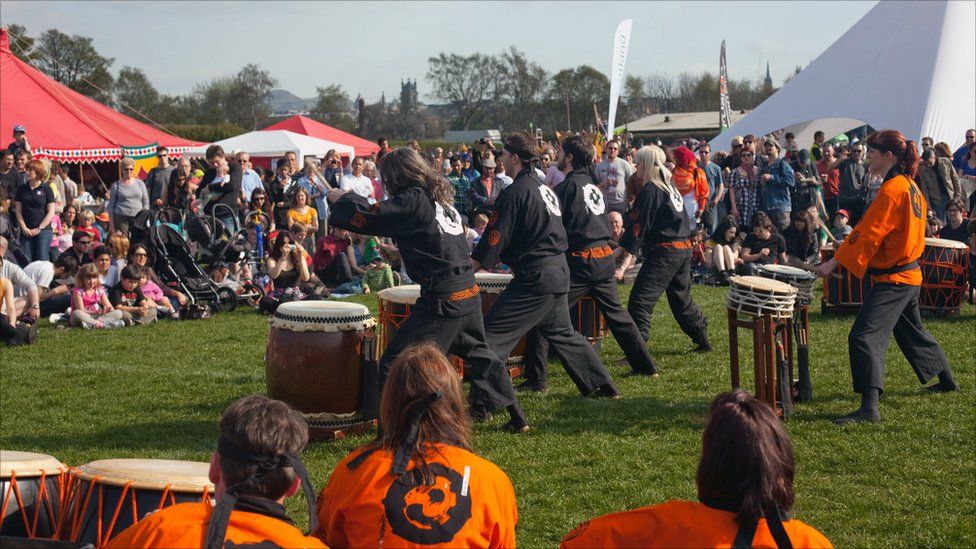 Drummers perform before a crowd