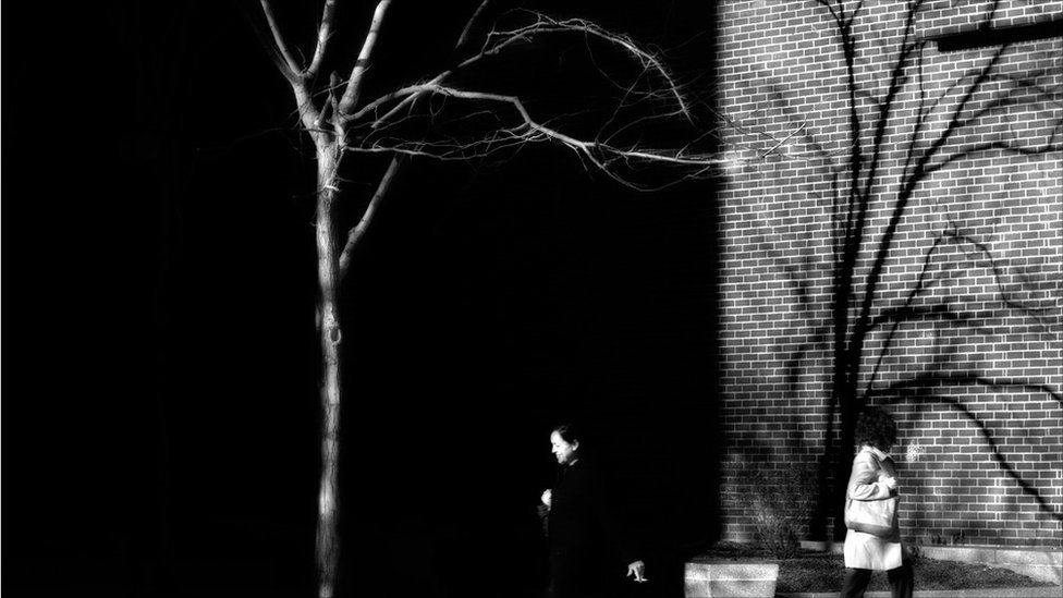 People walking between buildings in Boston, Massachusetts.