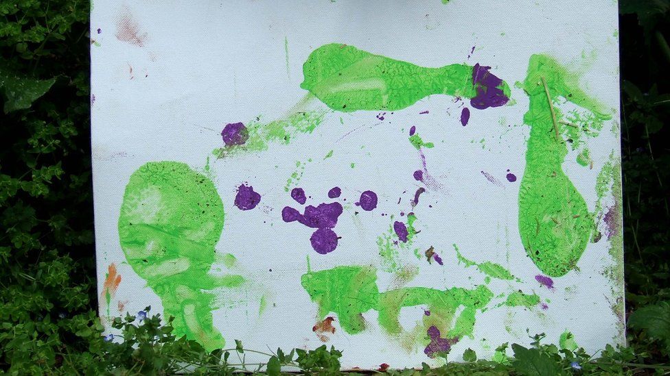 One of N'Dowe the lowland gorilla's paintings with green and purple paint.