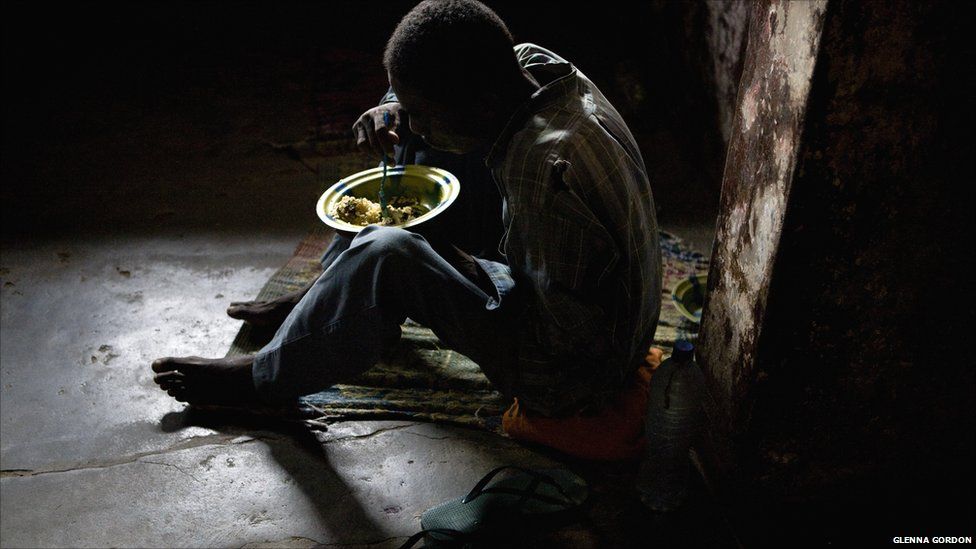 A prisoner at Liberia's Monrovia Central Prison eats a bowl of rice - 2011