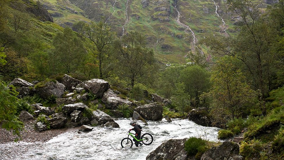 Biker crossing water in Glencoe
