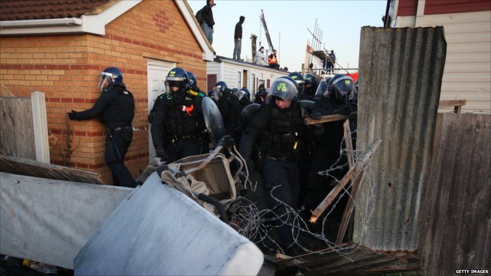 Riot police break through fencing on 19 October