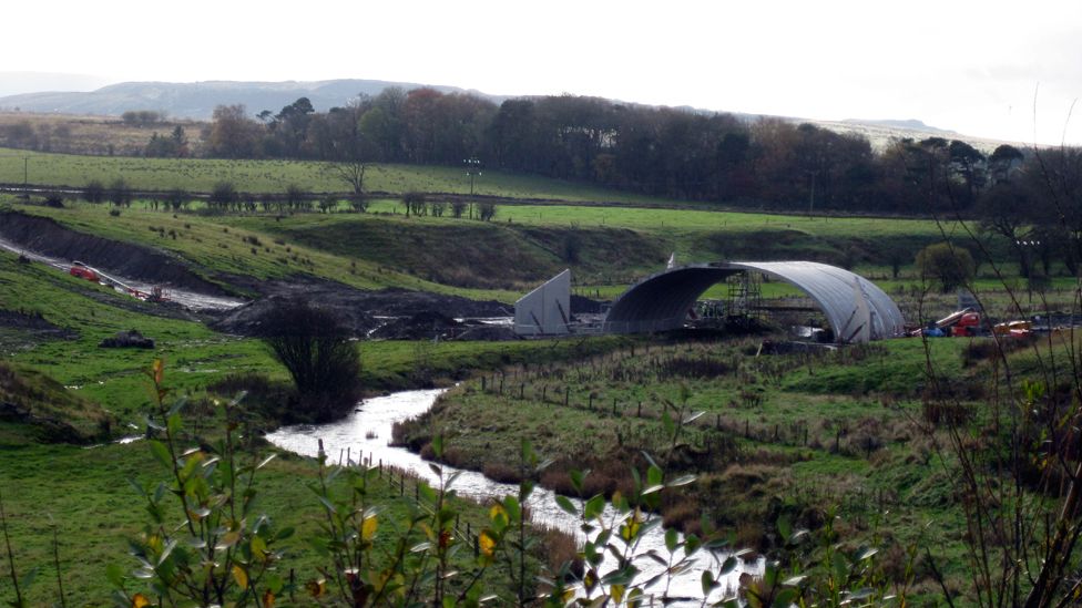 Precast bridge being erected over a river