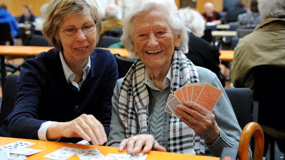 Christine Hess, left, plays cards with her mother Maria Hess in a school in Koblenz, Germany, on 4 December 2011