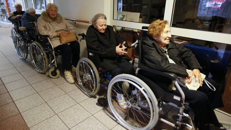 Pensioners line up in wheelchairs to be evacuated from a retirement home in Koblenz, Germany, on 4 December 2011