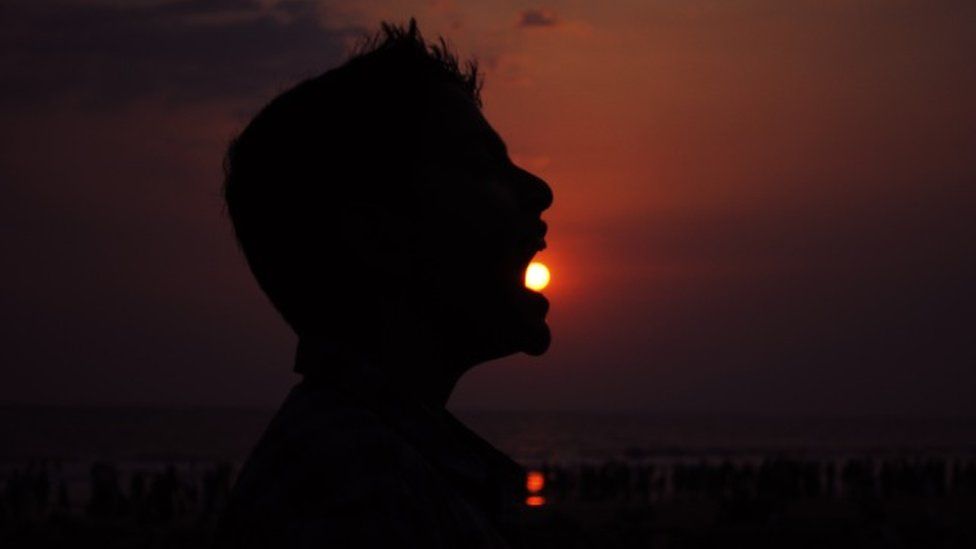 Man appears to swallow the Sun
