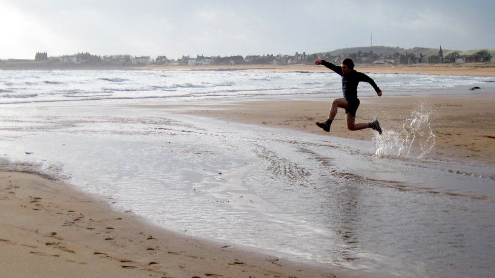 Jonathan running along Elie beach
