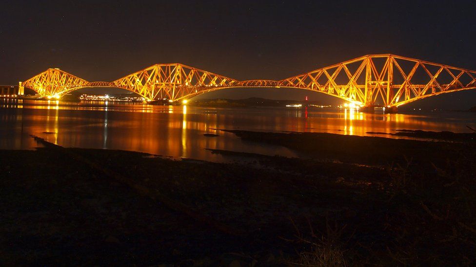 Forth Bridge illuminated at night