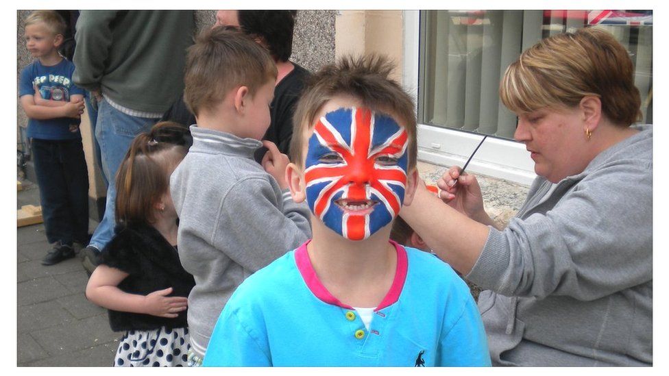 Boy with his face painted with the Union Jack