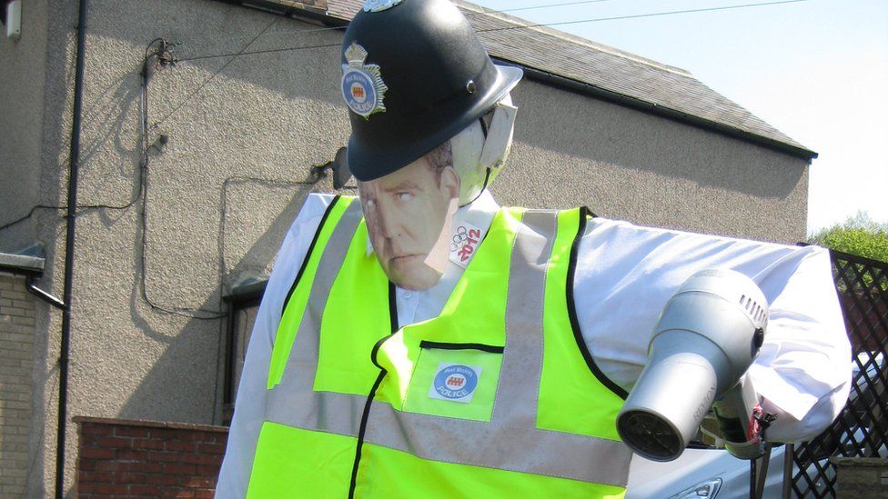 Scarecrow policeman with picture of Jeremy Clarkson's face