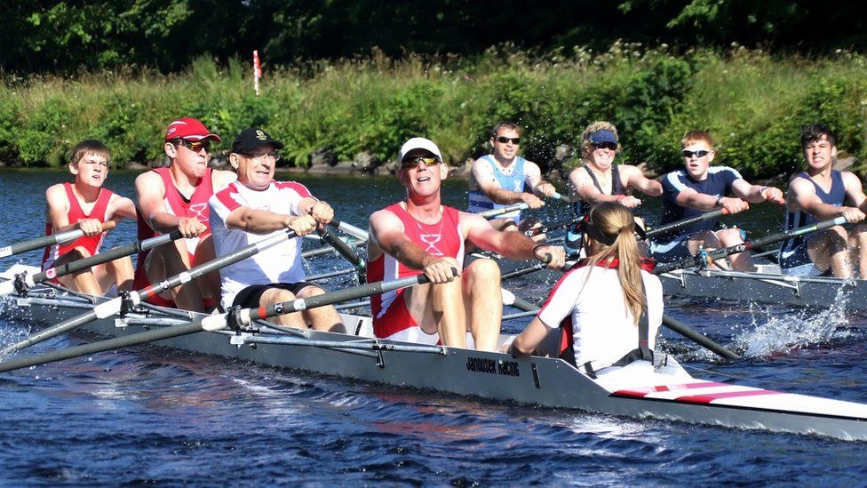 Teams of rowers racing in the water