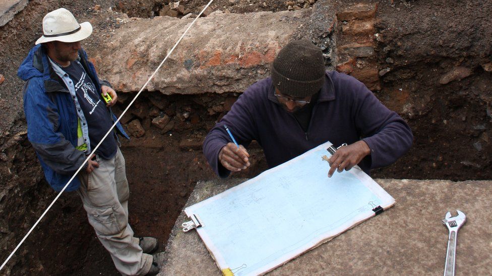 Mathew Morris (left) and colleague record the grave