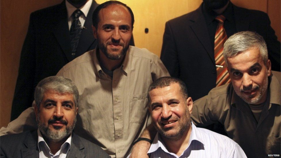 Ahmed Jabari (bottom right) poses with Hamas leader Khaled Meshal (bottom left) in Cairo last year.