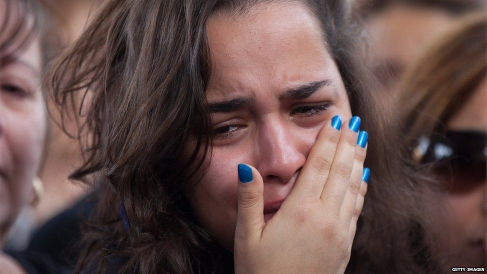 A woman mourns at the funeral of Itzik Amsalem