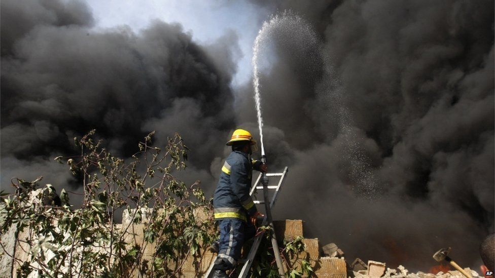Firefighter trains jet of water on fire in Jabaliya north Gaza