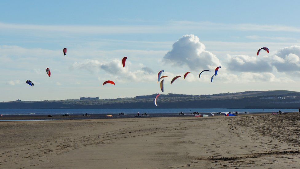 People flying kites