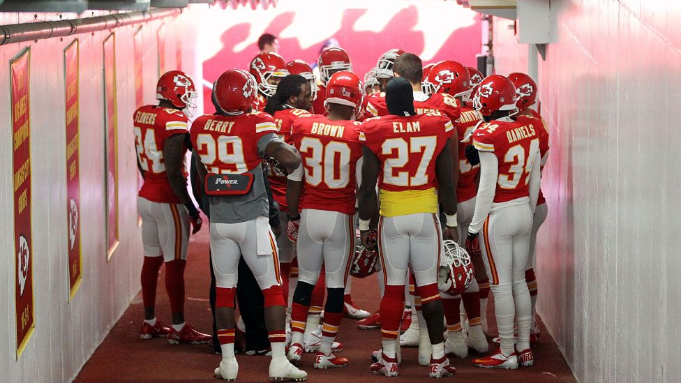 Kansas City Chiefs players huddle in prayer in the tunnel to the field before their game against the Carolina Panthers at Arrowhead Stadium in Kansas City, Missouri, 2 December 2012