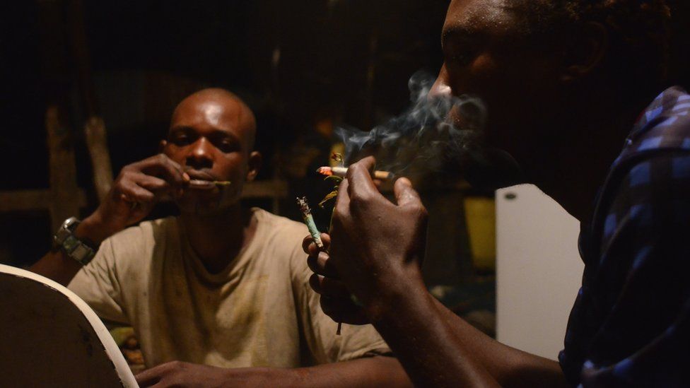 Fishermen smoking and chewing khat in a shack in Mombasa's old port