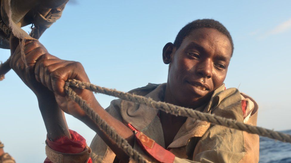 Bubu, aboard a Kenyan fishing vessel, hoisting the sail