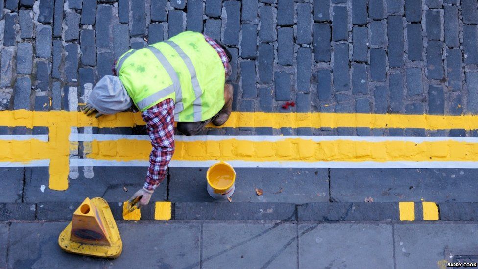 Workman painting yellow lines